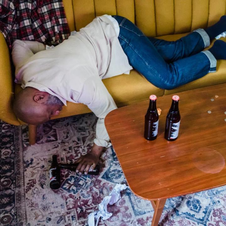 Man struggling and feeling trapped from drinking too much like what happens when you spiral too hard living alone after moving out