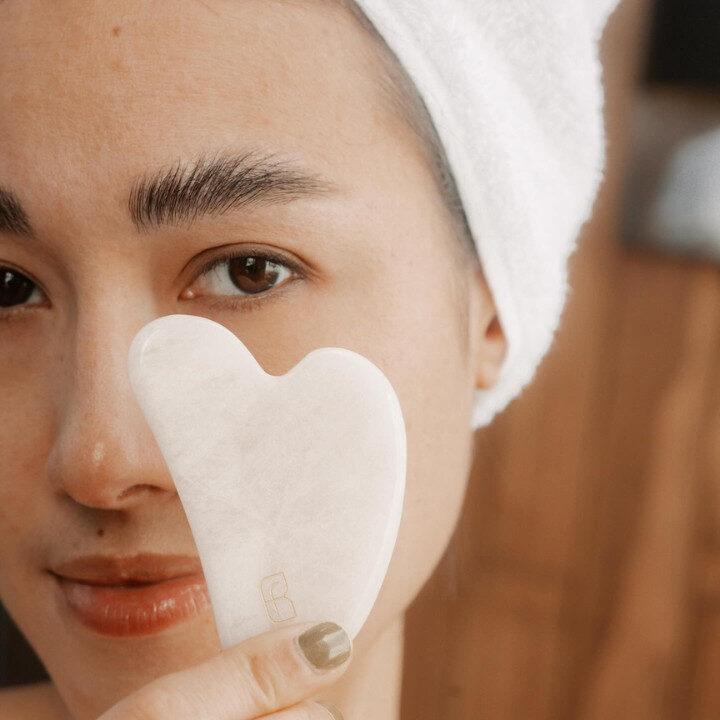 woman holding gua sha