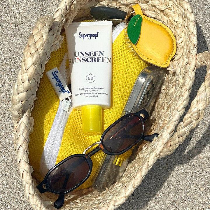 supergoop unseen sunscreen in beach bag