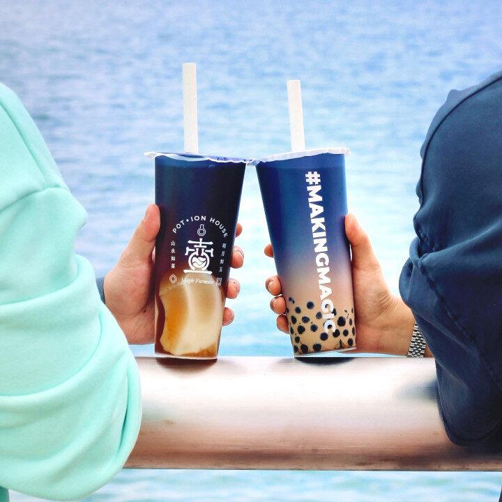 two people holding bubble tea