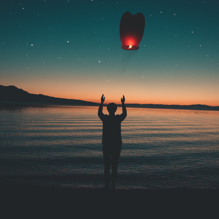 person releasing a lantern autistic masking